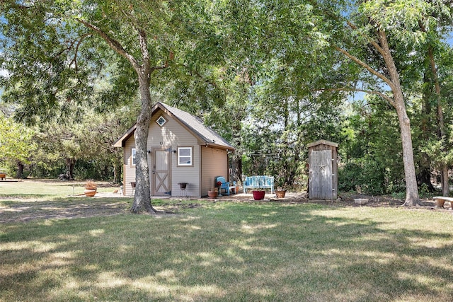 view of side of home featuring a storage unit and a lawn