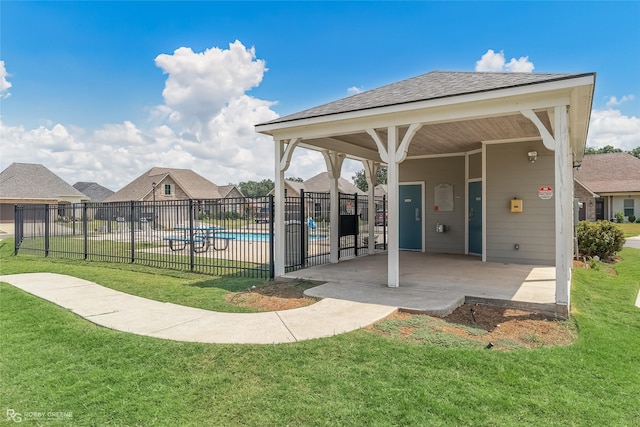 view of property's community with a yard, a patio, fence, and a pool