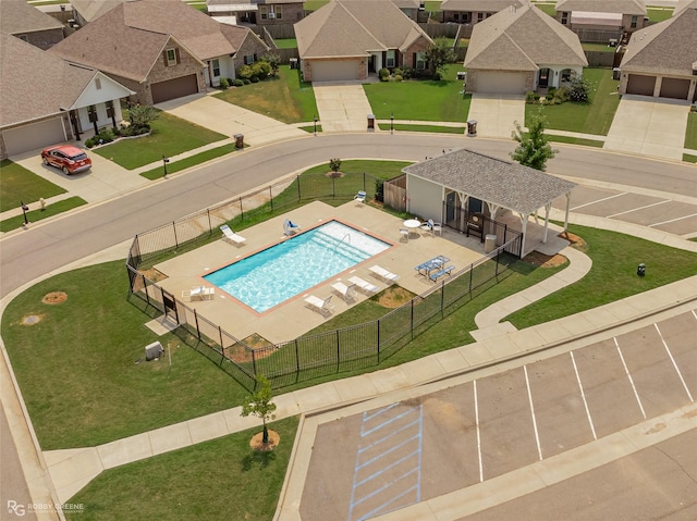 community pool featuring a residential view, a gazebo, fence, a yard, and a patio area