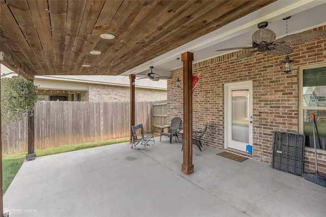 view of patio with ceiling fan and fence