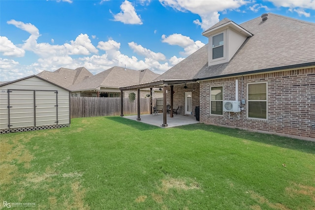 view of yard with an outbuilding, a fenced backyard, a patio, and a storage unit