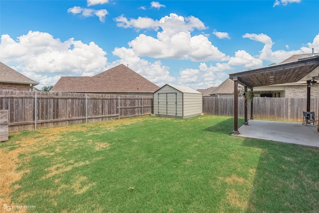 view of yard with a storage shed, a fenced backyard, an outbuilding, and a patio