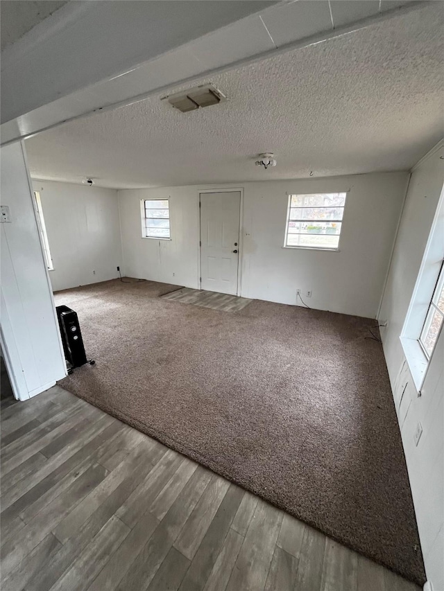 unfurnished room featuring carpet floors and a textured ceiling