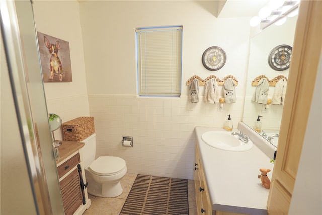 bathroom featuring vanity, tile walls, toilet, and tile patterned floors