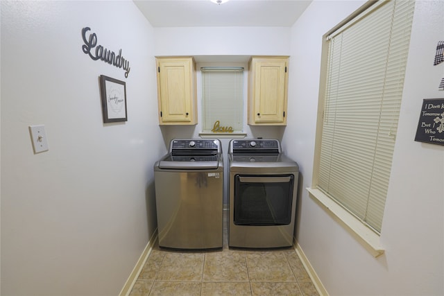 laundry room with light tile patterned floors, independent washer and dryer, and cabinets