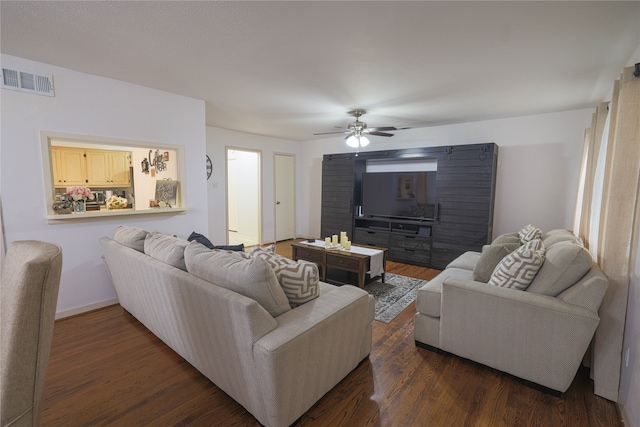 living room featuring ceiling fan and dark hardwood / wood-style floors