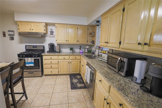 kitchen featuring sink, light brown cabinets, appliances with stainless steel finishes, and light tile patterned flooring