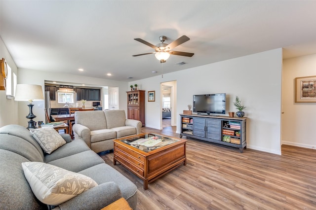 living room with hardwood / wood-style floors and ceiling fan