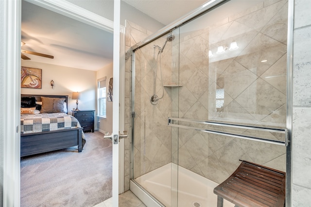 bathroom with ceiling fan and an enclosed shower