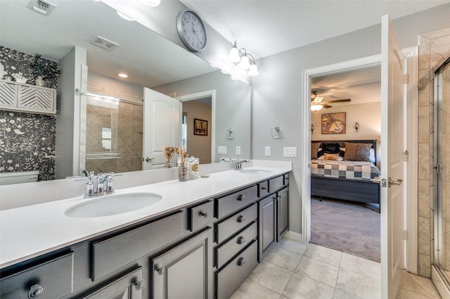 bathroom featuring ceiling fan, tile patterned flooring, vanity, and an enclosed shower