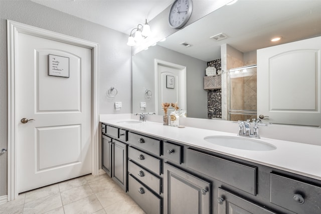 bathroom with tile patterned flooring, vanity, and an enclosed shower