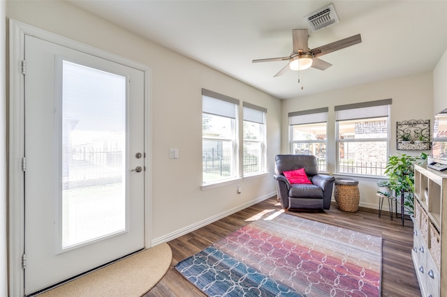 sitting room featuring ceiling fan and dark wood-type flooring