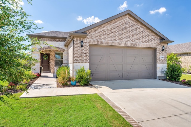 view of front of home with a front yard and a garage