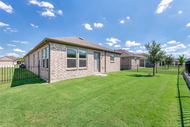 rear view of property with a yard