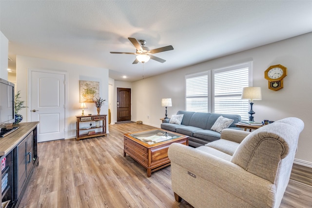 living room with ceiling fan and light wood-type flooring