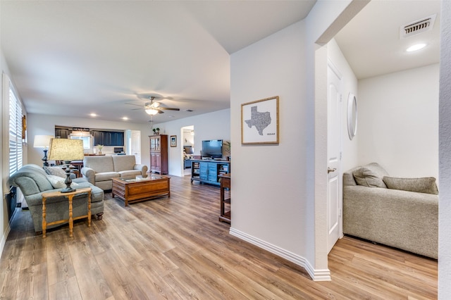 living room featuring ceiling fan and hardwood / wood-style flooring