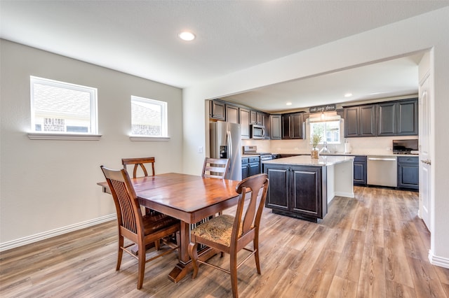 dining space featuring light hardwood / wood-style flooring and sink