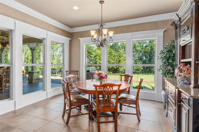 dining space featuring ornamental molding, plenty of natural light, and a chandelier