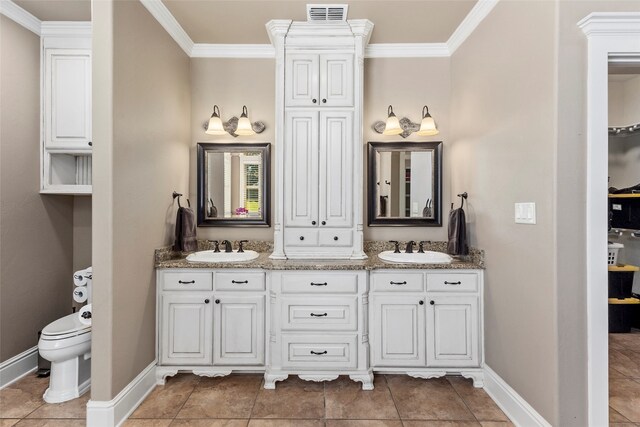 bathroom featuring tile patterned floors, toilet, ornamental molding, and vanity