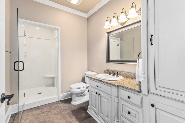 bathroom featuring crown molding, vanity, a shower with shower door, and toilet