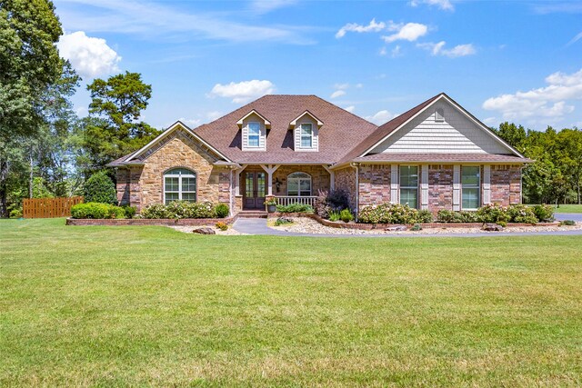 view of front of property featuring a porch and a front lawn