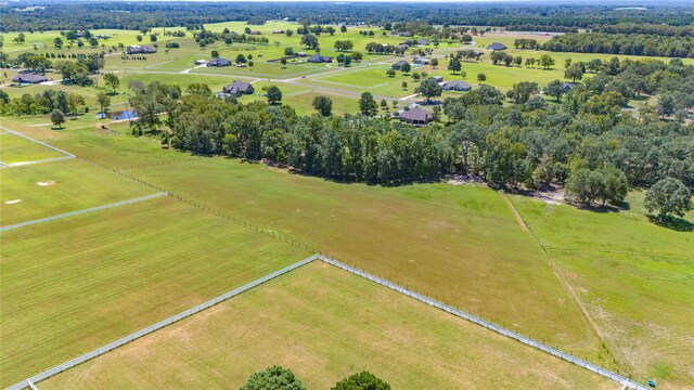 birds eye view of property with a rural view