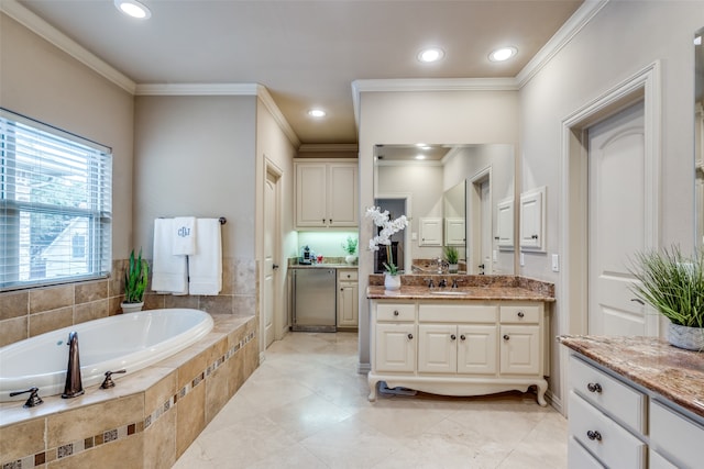 bathroom with a relaxing tiled tub, vanity, and crown molding