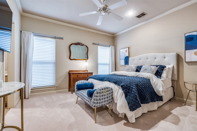 carpeted bedroom featuring ceiling fan, ornamental molding, and multiple windows