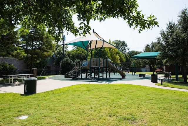 surrounding community with a lawn and a playground