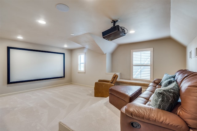 cinema featuring light carpet and vaulted ceiling