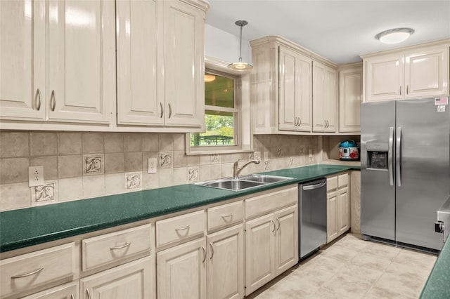 kitchen featuring hanging light fixtures, decorative backsplash, sink, and appliances with stainless steel finishes