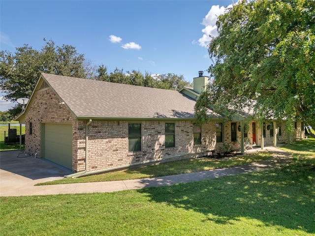 view of front of home with a garage and a front lawn