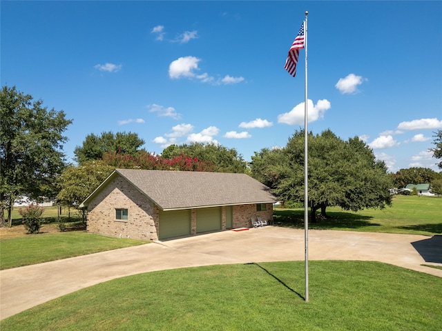 view of front of house featuring a garage and a front lawn