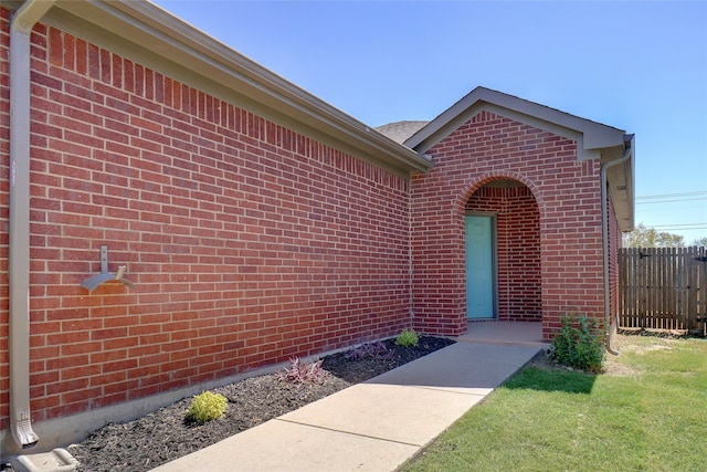 property entrance with a lawn