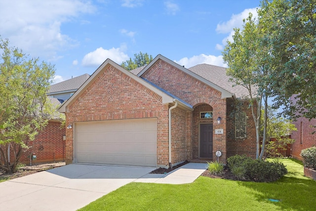 front facade featuring a garage and a front lawn