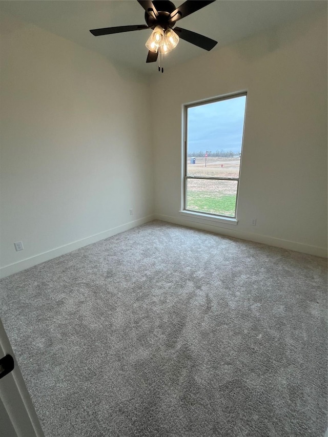 carpeted empty room featuring ceiling fan