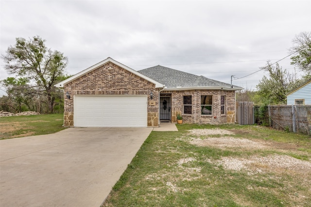 view of front of property featuring a garage and a front yard