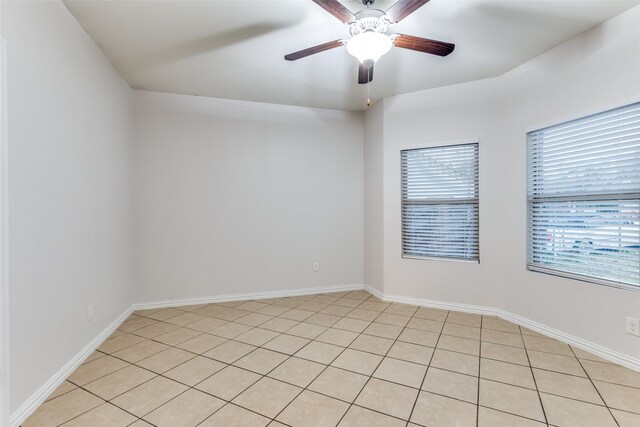 spare room featuring light tile patterned floors and ceiling fan