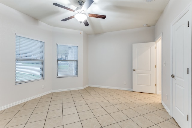 spare room featuring ceiling fan and light tile patterned floors