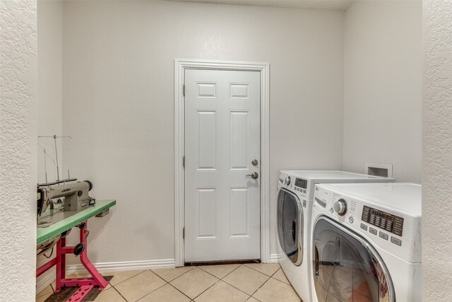 laundry area featuring light tile patterned flooring and washer and dryer