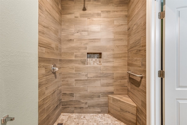 bathroom with a tile shower