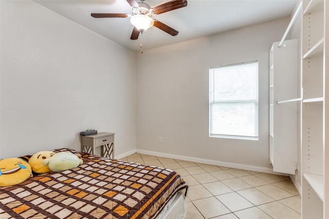 tiled bedroom featuring ceiling fan