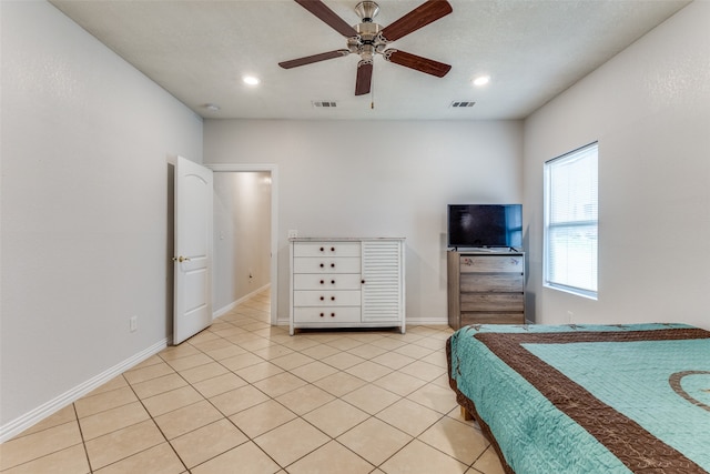 tiled bedroom featuring ceiling fan