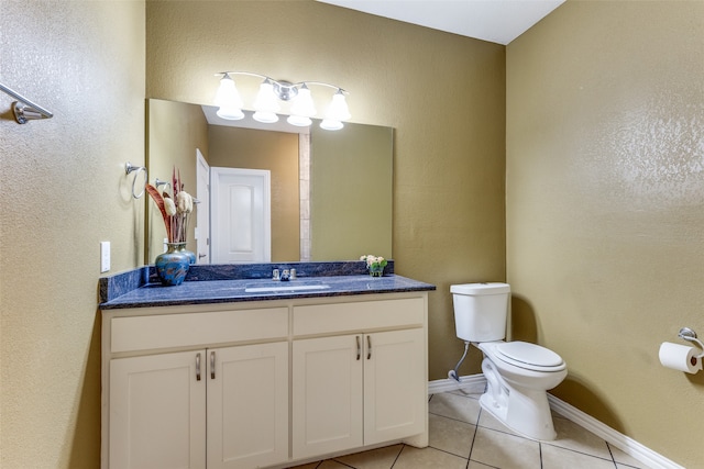 bathroom featuring vanity, toilet, and tile patterned floors