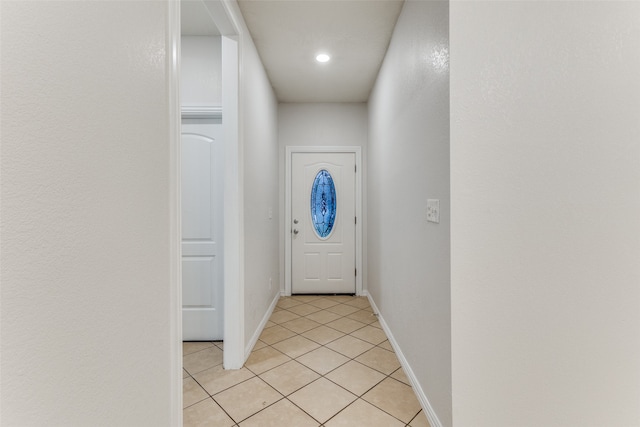 doorway to outside with light tile patterned floors