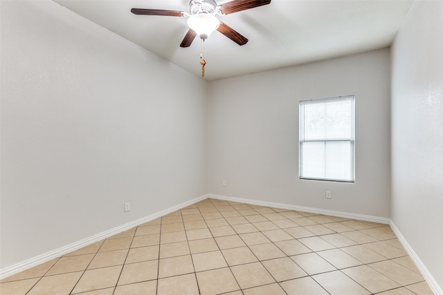 tiled empty room featuring ceiling fan