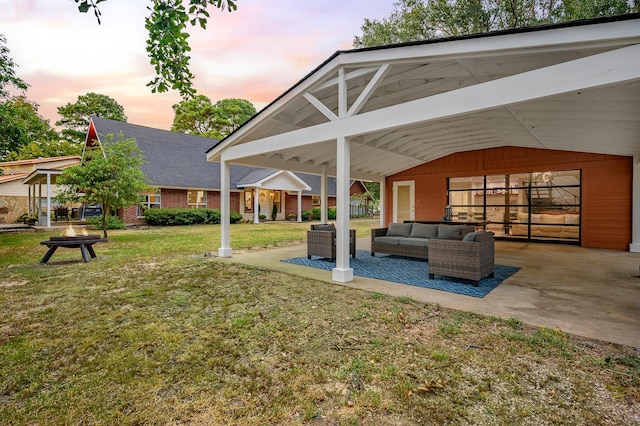 exterior space with a yard, a patio, and an outdoor living space with a fire pit