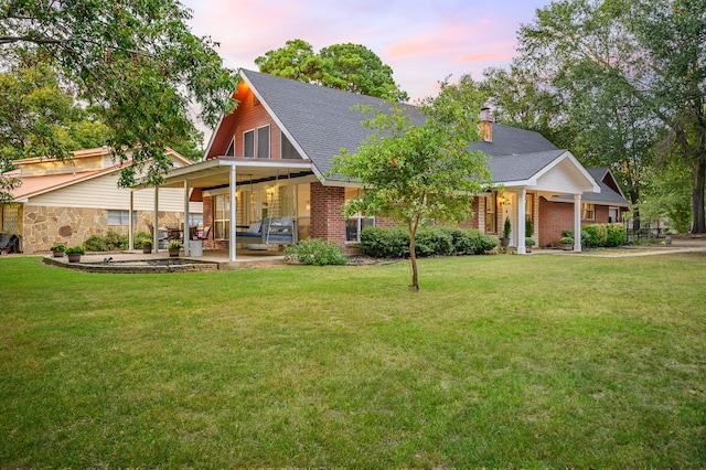 view of front of home featuring a patio area and a yard