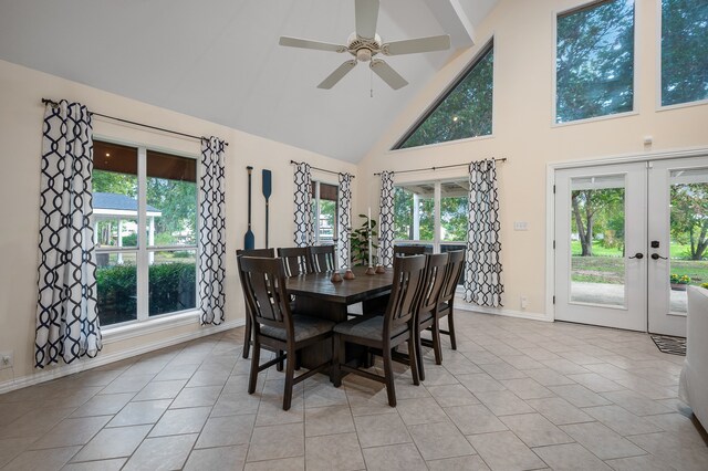 tiled dining area featuring ceiling fan, high vaulted ceiling, and french doors