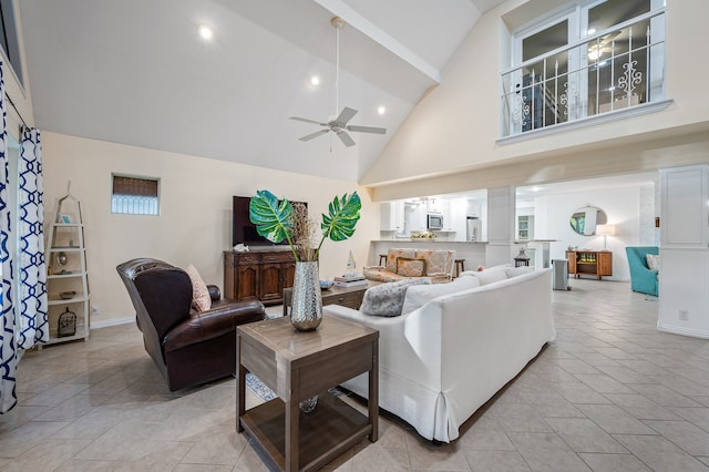 living room with ceiling fan and high vaulted ceiling